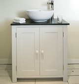 Bathroom vanity cabinet with Honed Black Granite top and countertop sink, painted in Bone White.